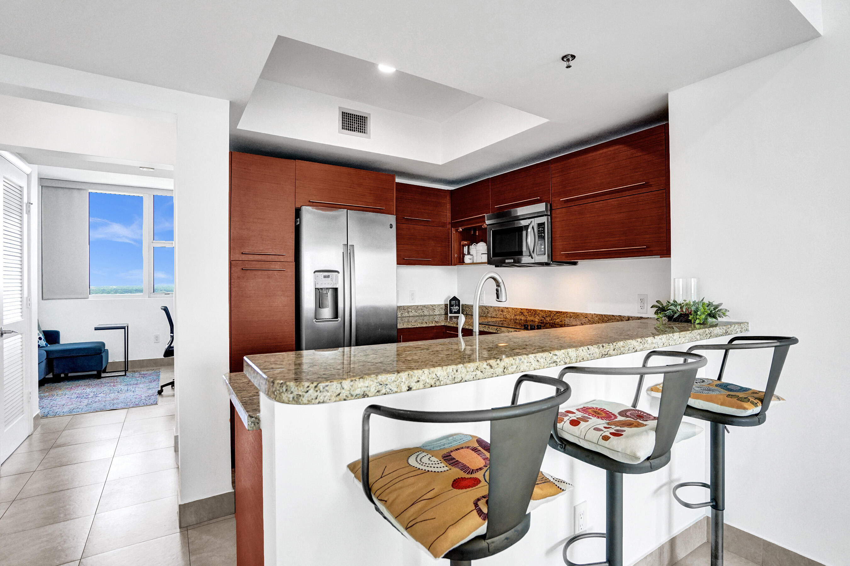 2641 North Flamingo Road, Unit 2105N Sunrise, FL 33323 - Photo 20 of 60 a kitchen with stainless steel appliances granite countertop a sink and a refrigerator