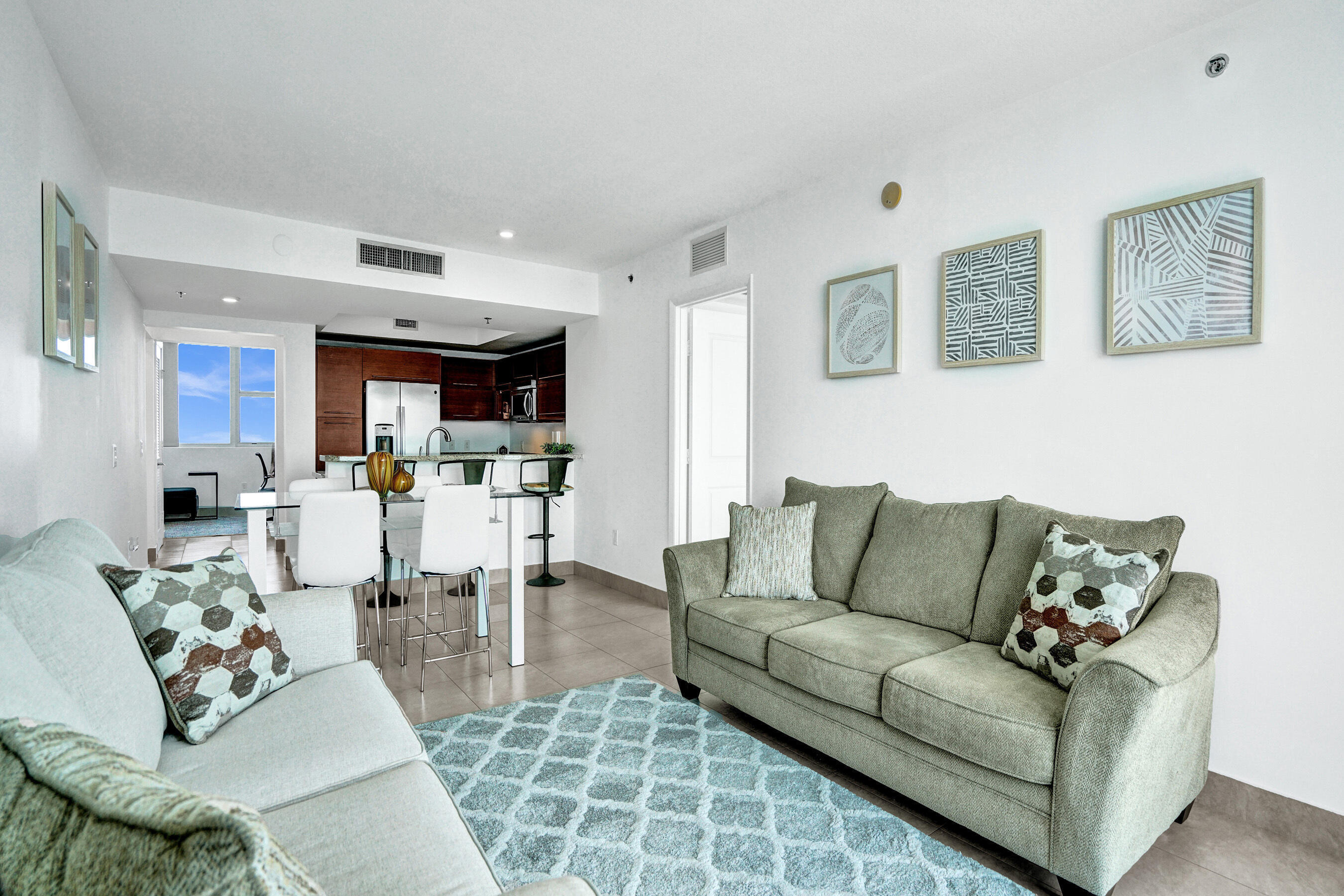 2641 North Flamingo Road, Unit 2105N Sunrise, FL 33323 - Photo 22 of 60 a living room with furniture kitchen view and a wooden floor