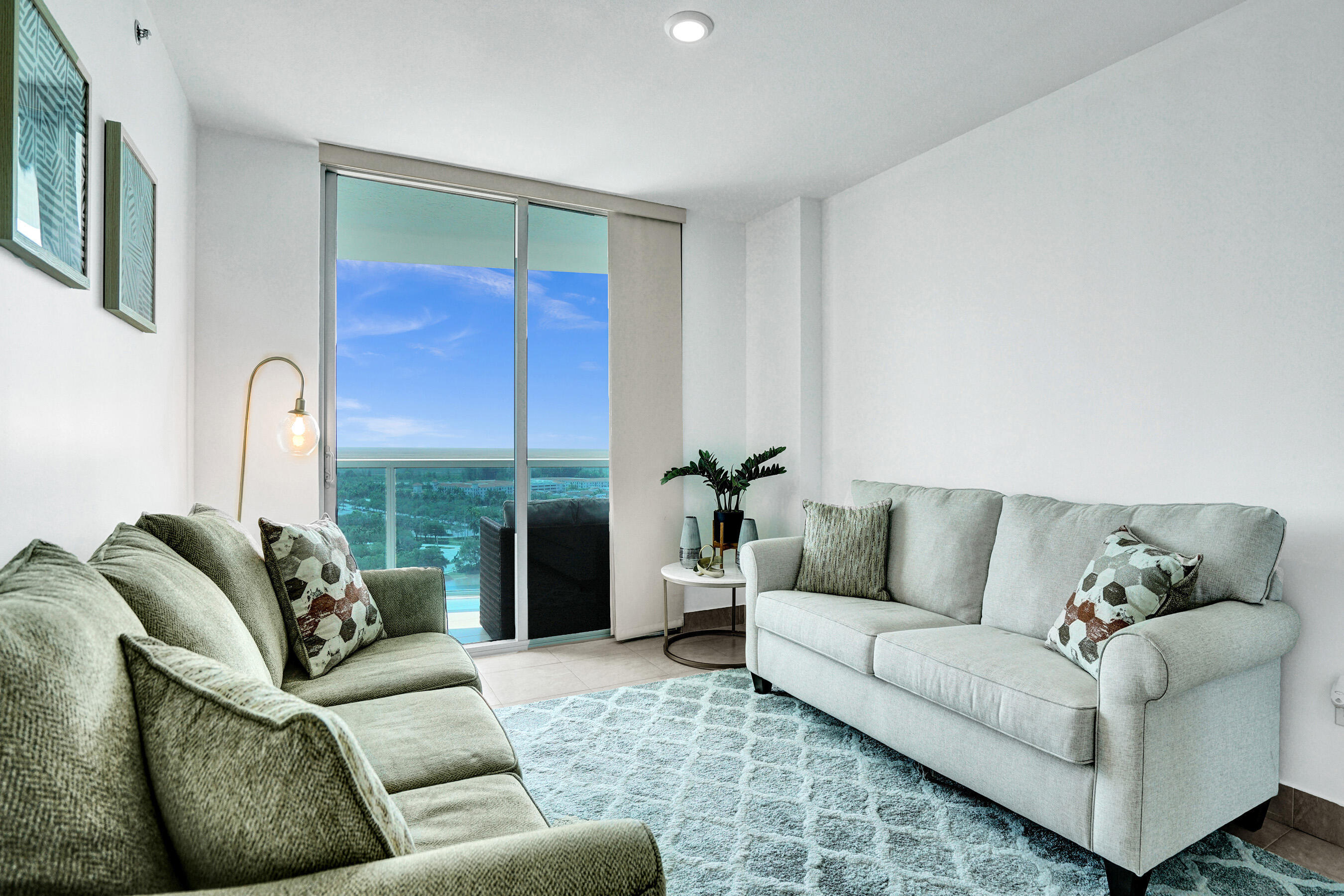 2641 North Flamingo Road, Unit 2105N Sunrise, FL 33323 - Photo 25 of 60 a living room with furniture and a potted plant