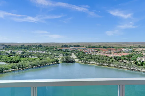 a living room with furniture a flat screen tv and a window