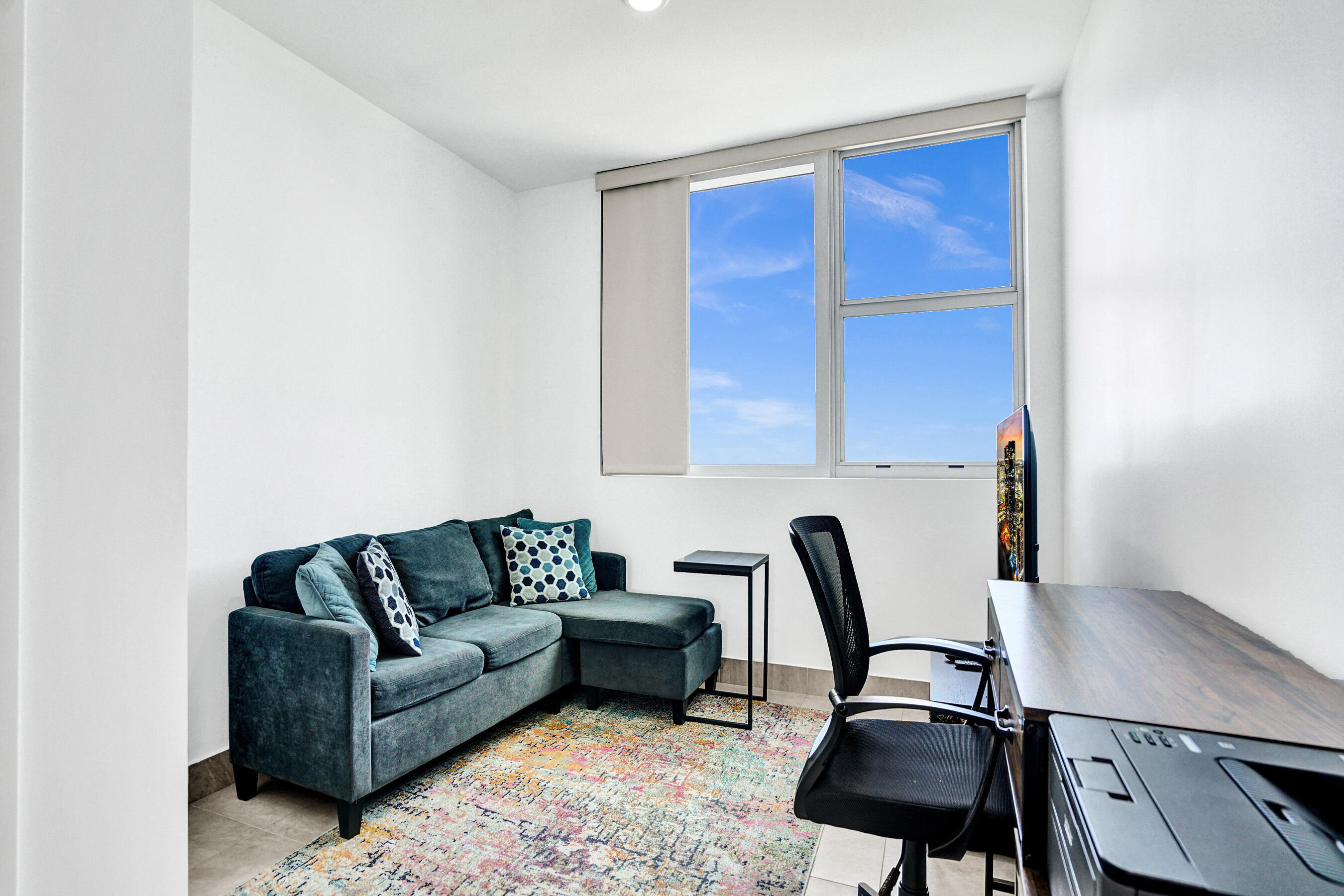 2641 North Flamingo Road, Unit 2105N Sunrise, FL 33323 - Photo 33 of 60 a living room with furniture a flat screen tv and a window