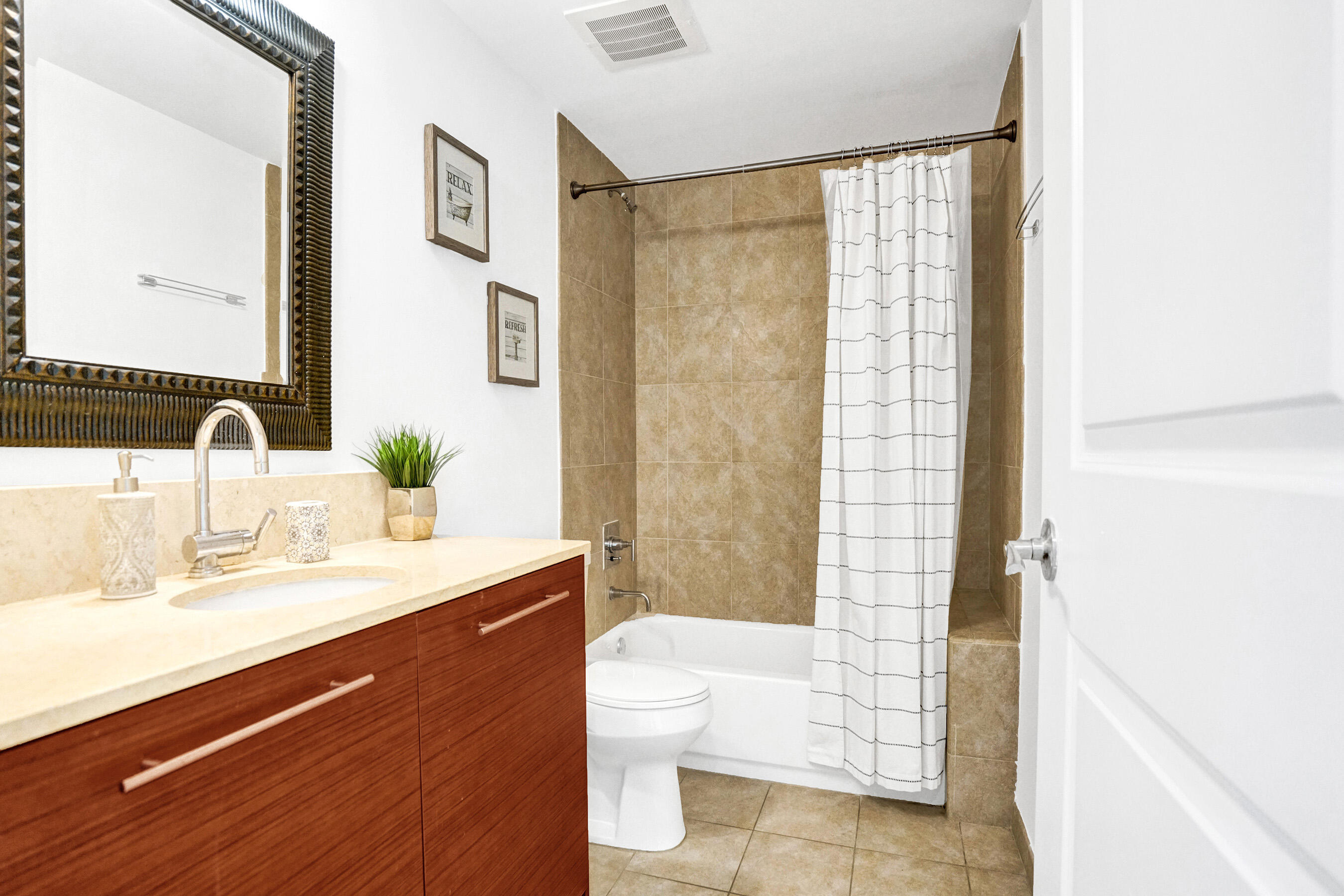 2641 North Flamingo Road, Unit 2105N Sunrise, FL 33323 - Photo 34 of 60 a bathroom with a double vanity sink toilet and shower