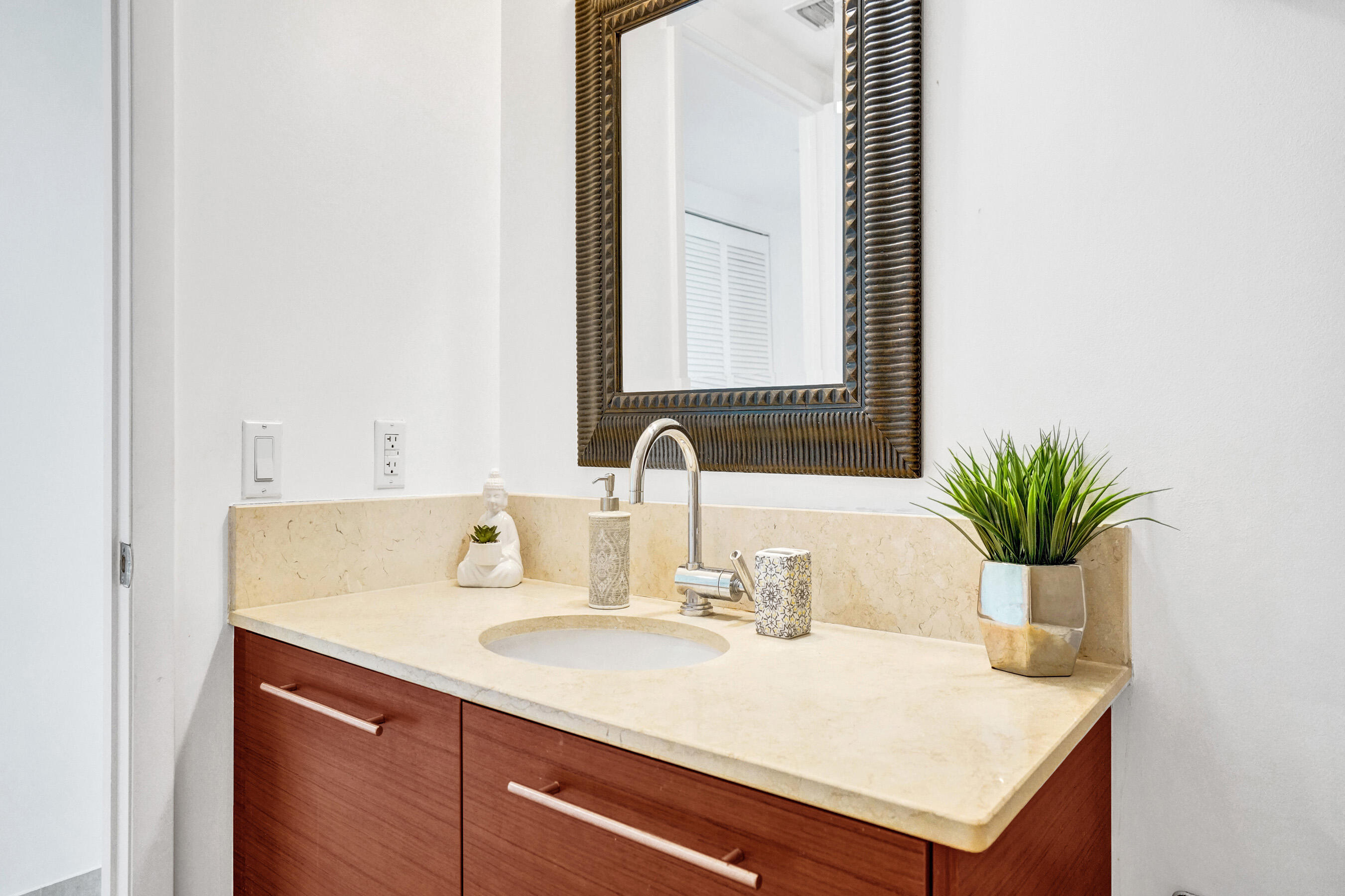 2641 North Flamingo Road, Unit 2105N Sunrise, FL 33323 - Photo 35 of 60 a bathroom with a sink and a mirror