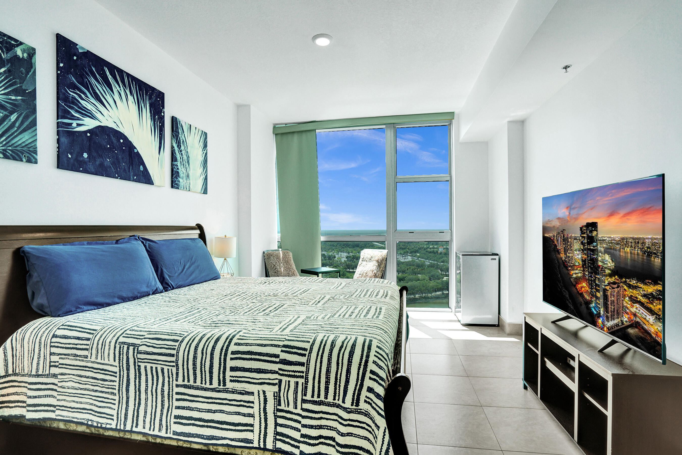 2641 North Flamingo Road, Unit 2105N Sunrise, FL 33323 - Photo 5 of 60 a bedroom with a bed and a flat screen tv