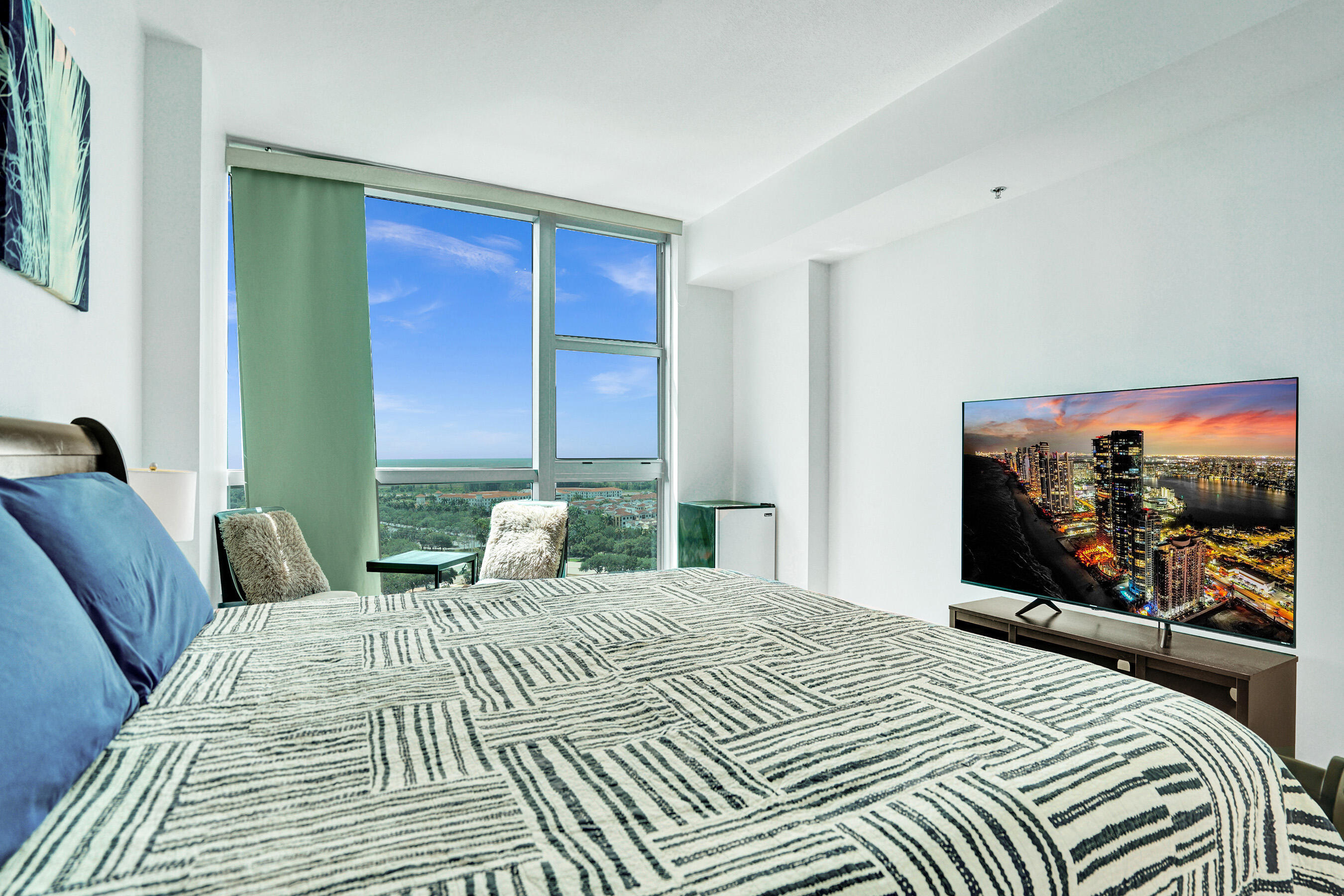 2641 North Flamingo Road, Unit 2105N Sunrise, FL 33323 - Photo 6 of 60 a bedroom with a bed and a flat screen tv