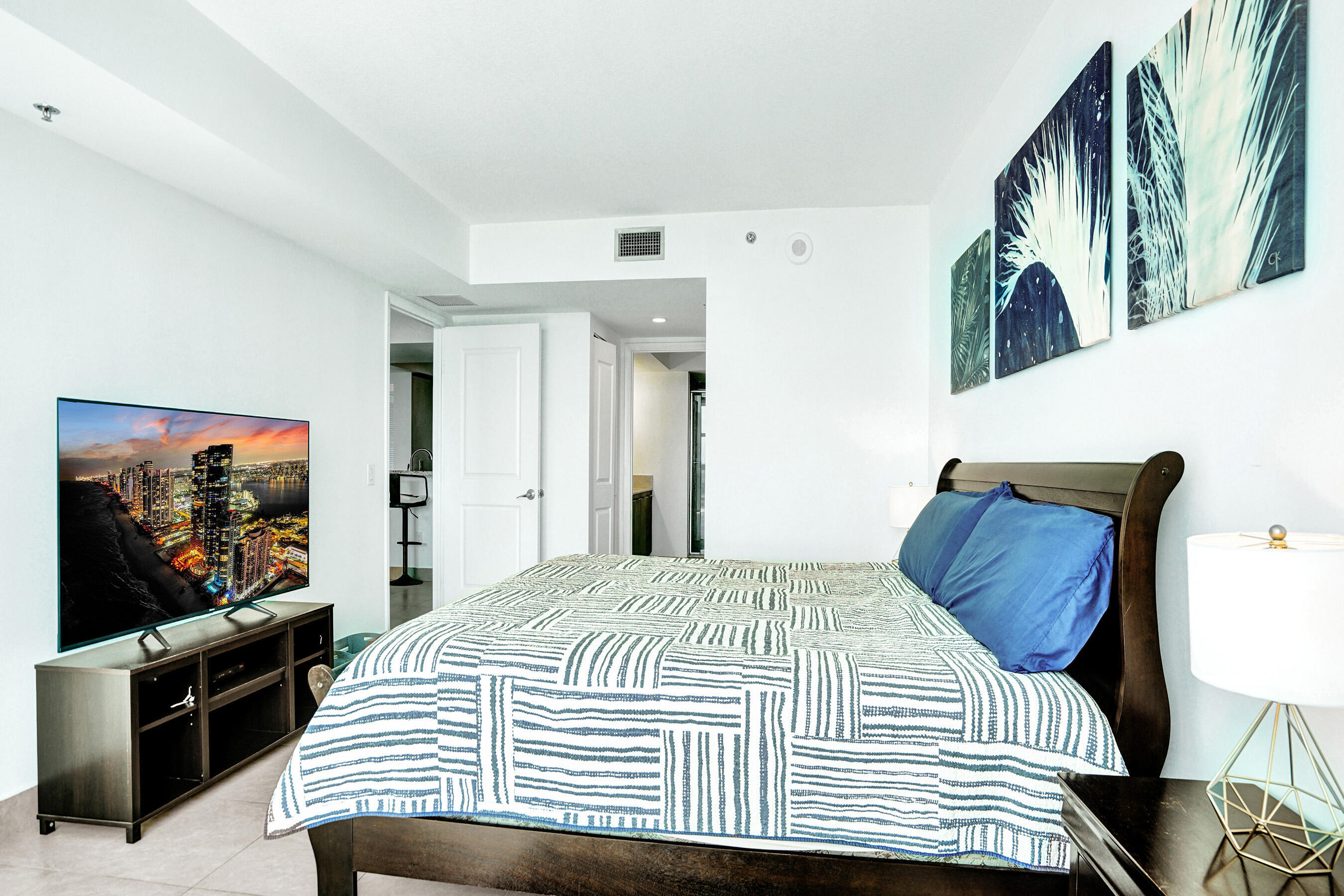 2641 North Flamingo Road, Unit 2105N Sunrise, FL 33323 - Photo 7 of 60 a bedroom with a bed and a flat screen tv