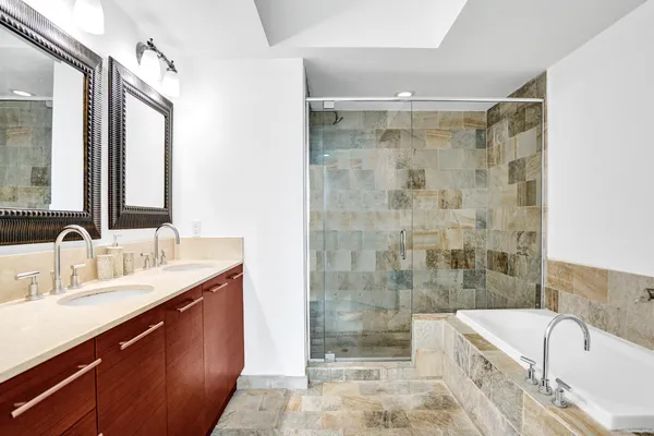 a bathroom with a bathtub and shower