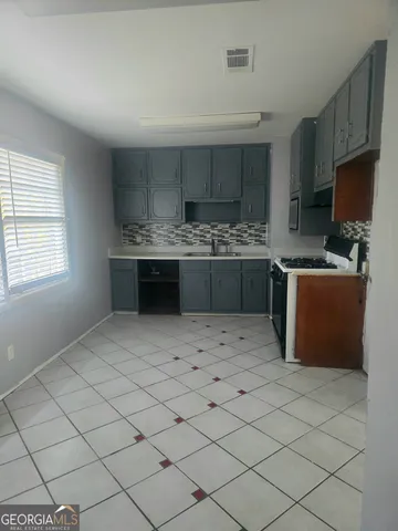 a kitchen with stainless steel appliances kitchen island granite countertop a sink and cabinets