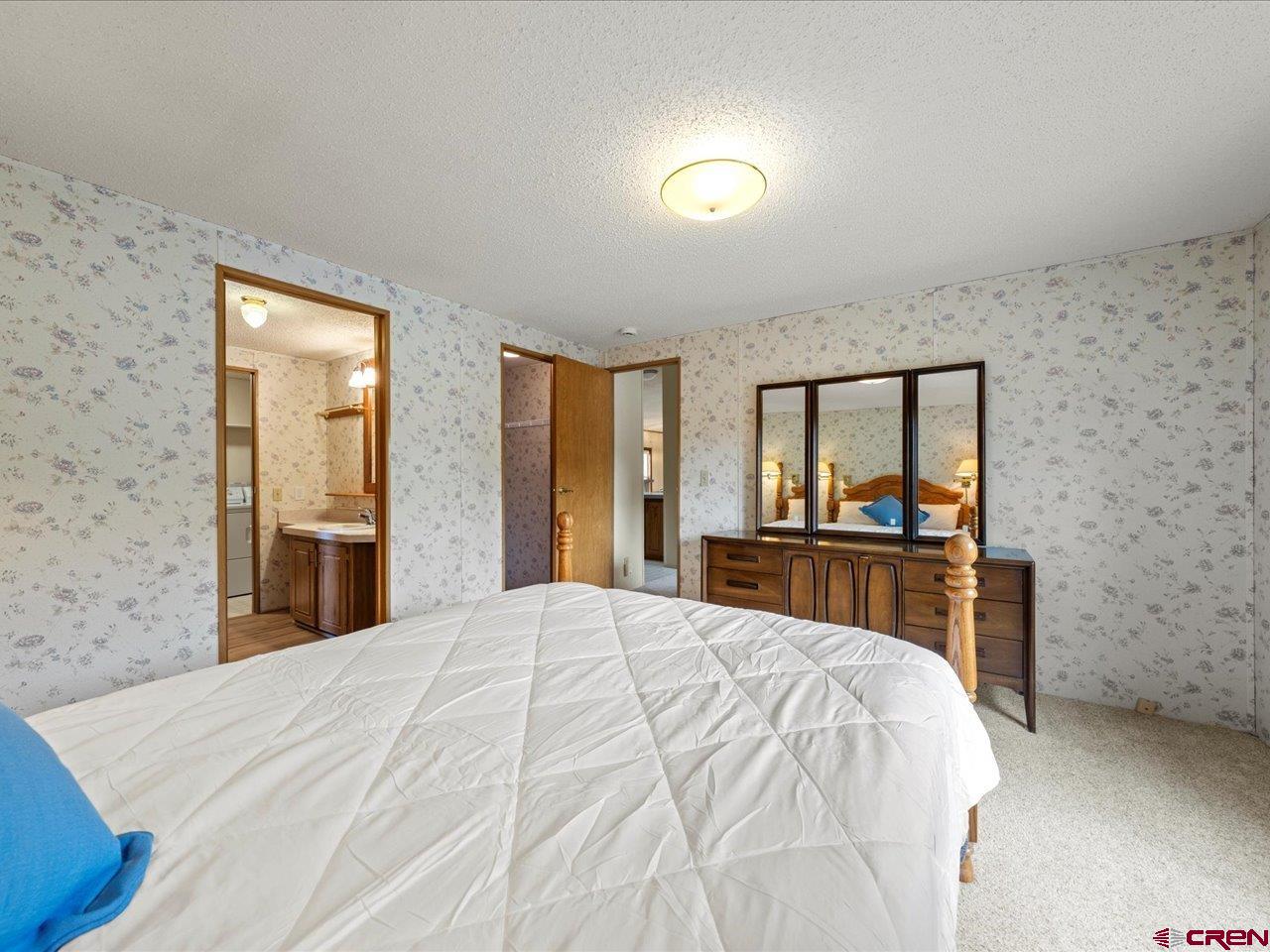 2602 1600th Road Delta, CO 81416 - Photo 13 of 42 a large bedroom with a bed and a dresser