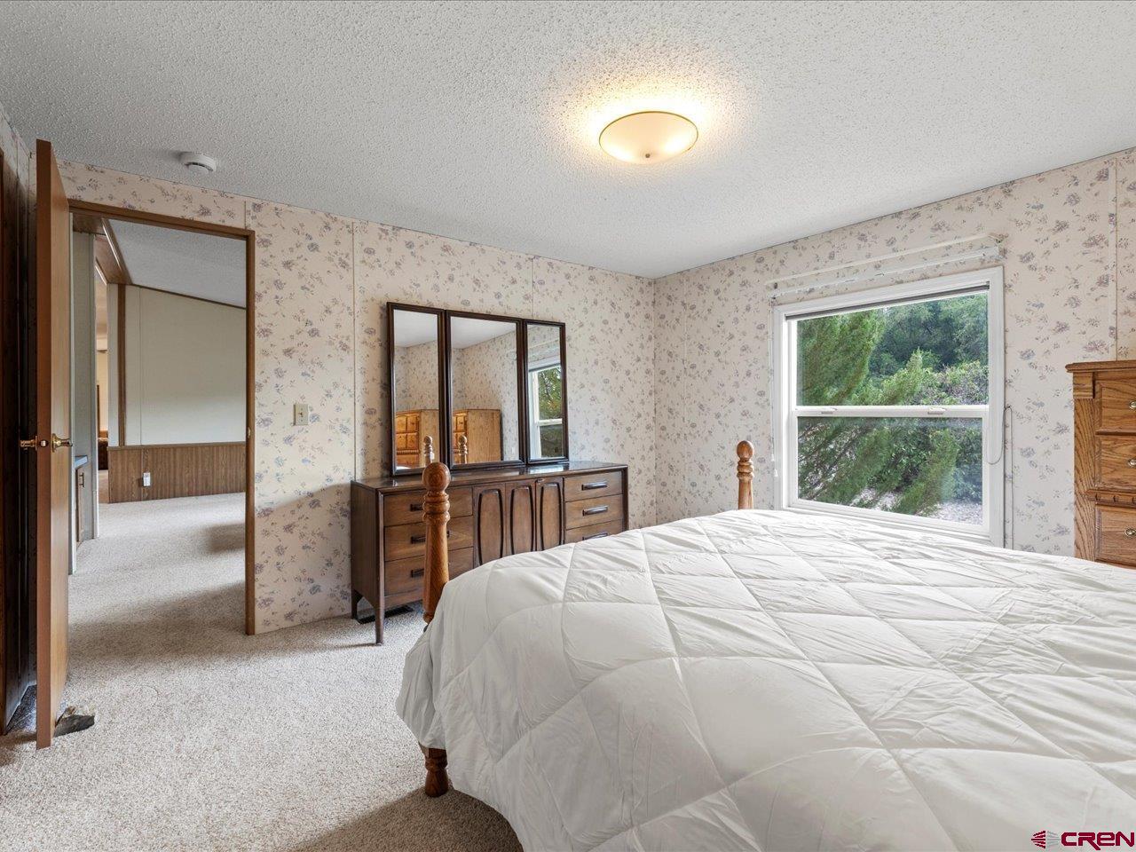 2602 1600th Road Delta, CO 81416 - Photo 14 of 42 a bed room with a bed and a large window