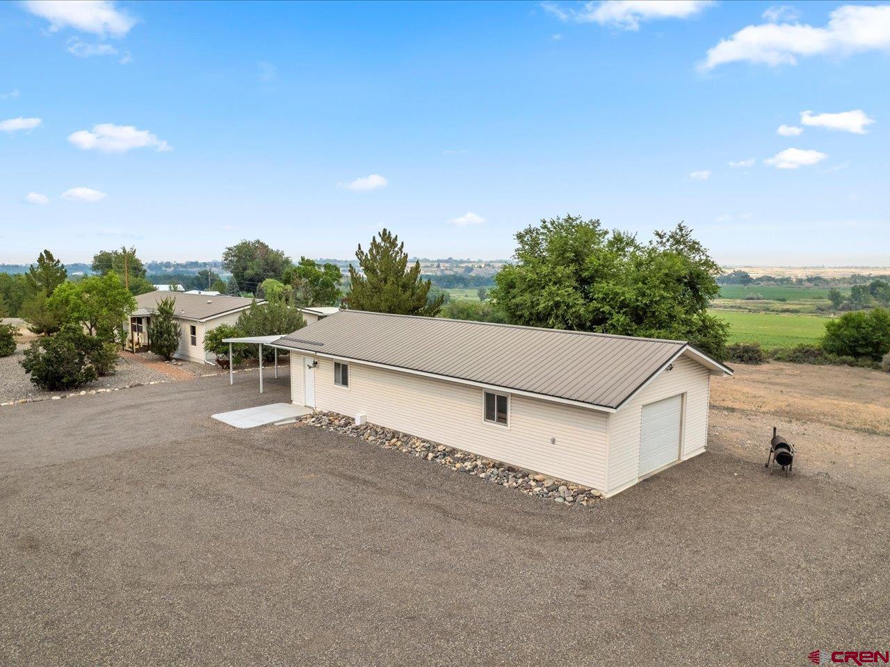 2602 1600th Road Delta, CO 81416 - Photo 35 of 42 a white bench sitting in middle of a field