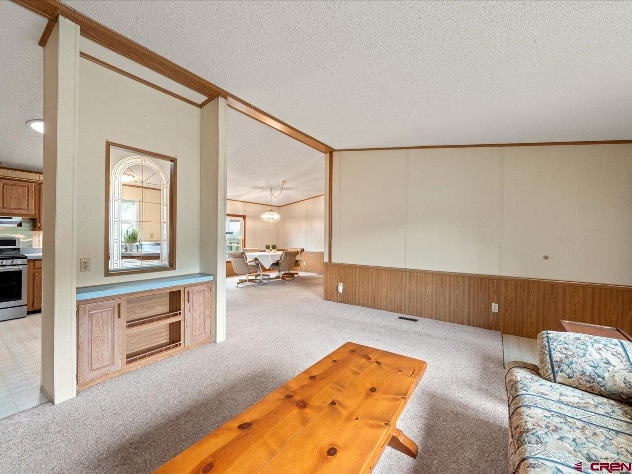 2602 1600th Road Delta, CO 81416 - Photo 6 of 42 a living room with a couch and chandelier