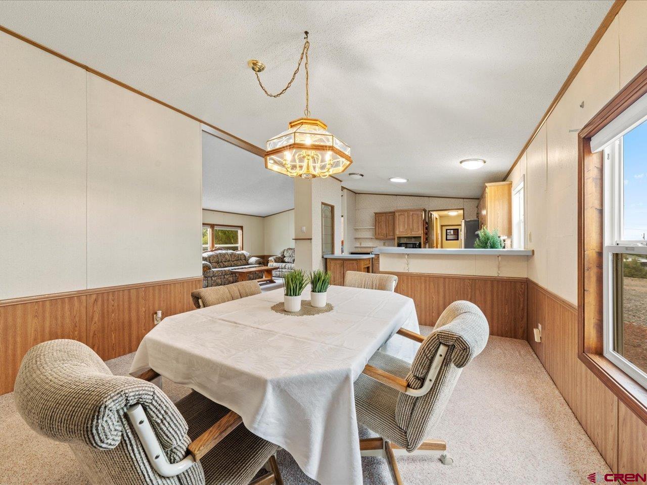 2602 1600th Road Delta, CO 81416 - Photo 10 of 42 a view of a dining room with furniture and a chandelier