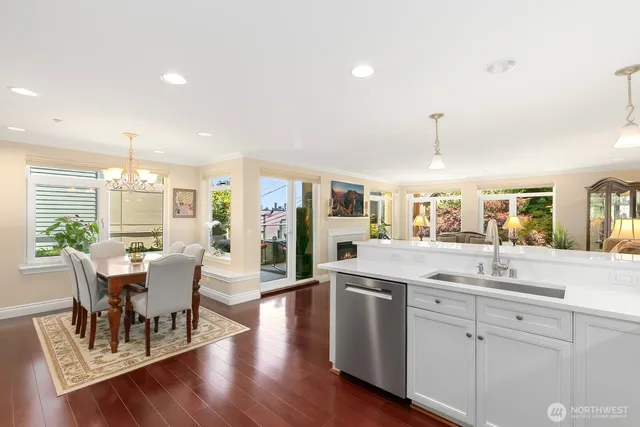 a open kitchen with white cabinets and stainless steel appliances