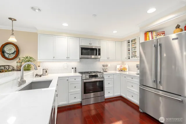 a kitchen with a stove a sink and a refrigerator