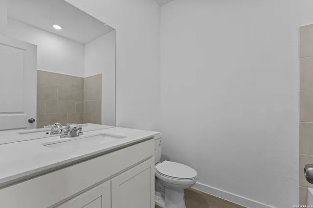 a bathroom with a sink a toilet and mirror