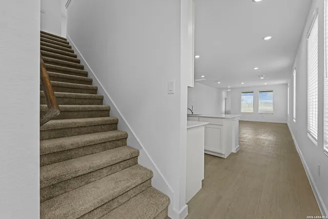a view of entryway and hall with wooden floor