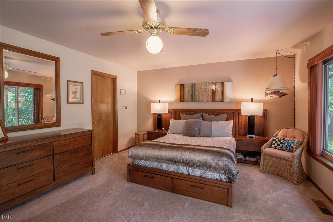 800 Cottonwood Road Reno, NV 89511 - Photo 12 of 20 a spacious bedroom with a bed a couch and a chandelier