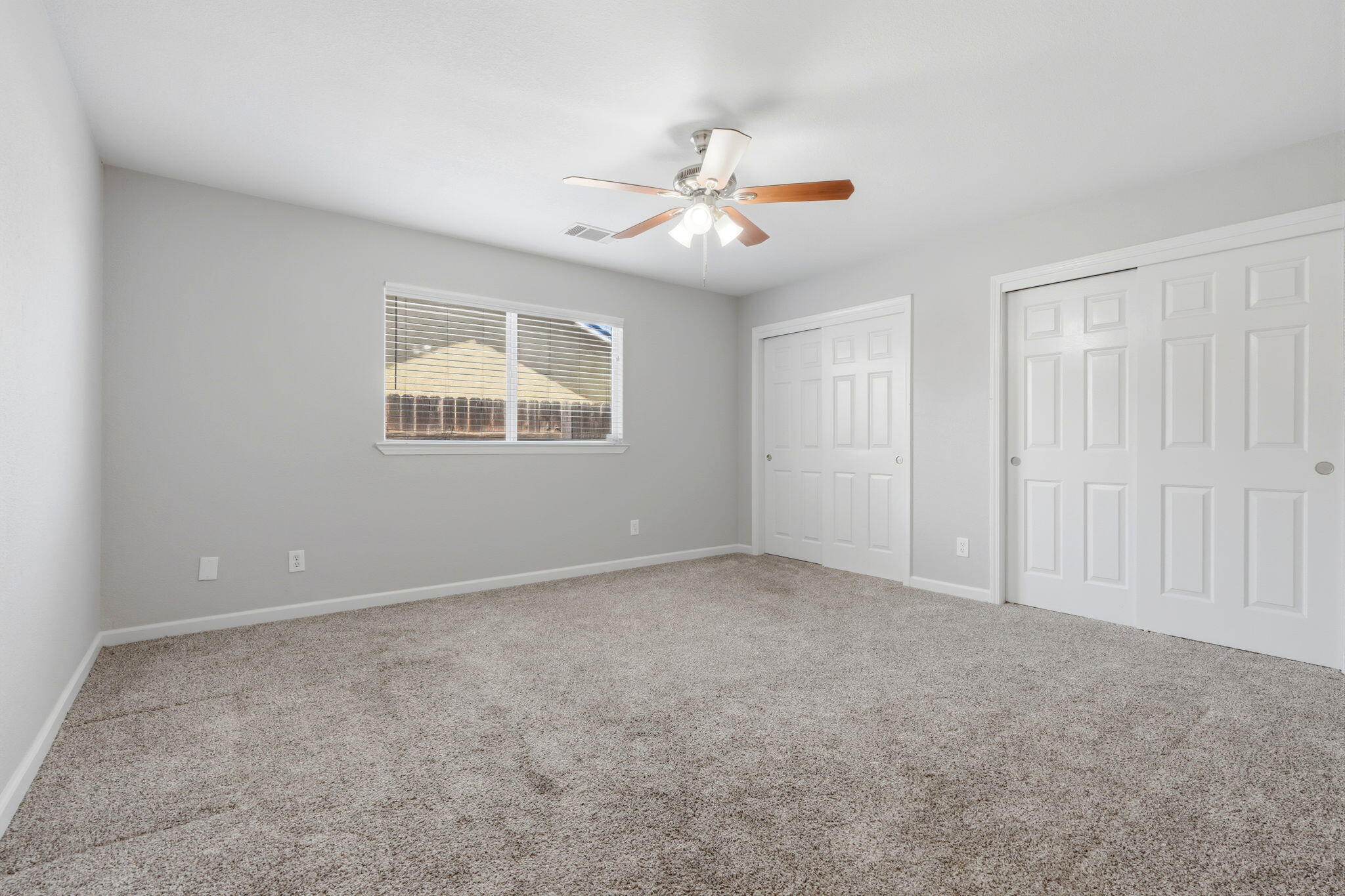 481 Katelyn Court Exeter, CA 93221 - Photo 15 of 33 an empty room with windows and fan