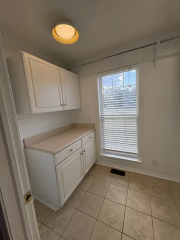 a kitchen with a cabinets and window