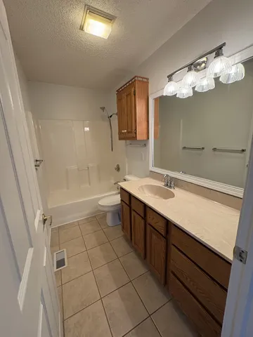 a bathroom with a sink a large mirror and a bathtub