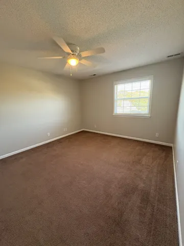 an empty room with a empty space and windows