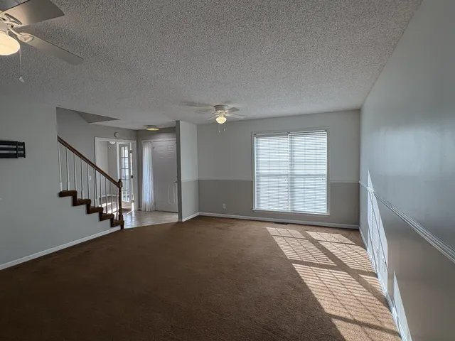 a view of empty room with stairs