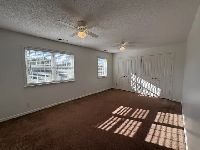 a view of wooden floor and windows in a room