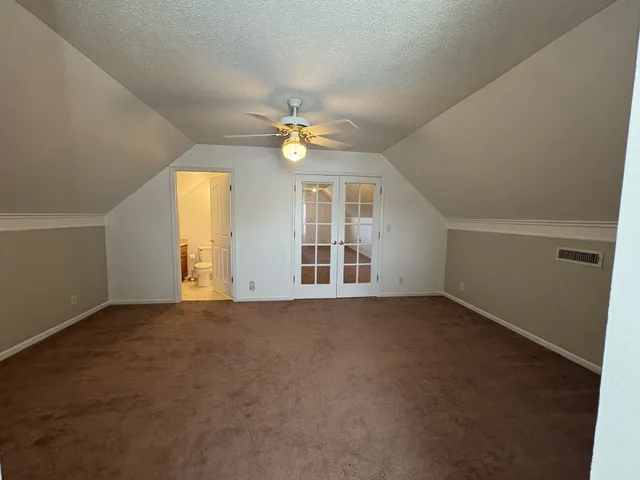 a bathroom with a glass door shower and toilet