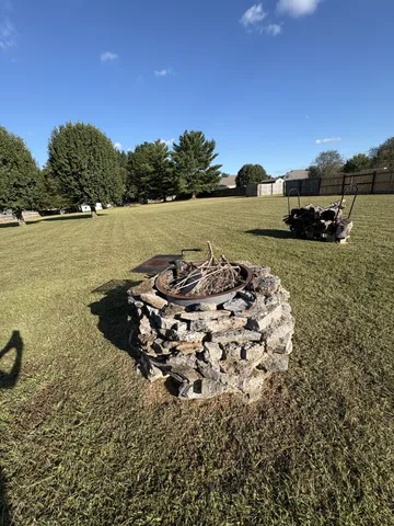 a backyard of a house with table and chairs