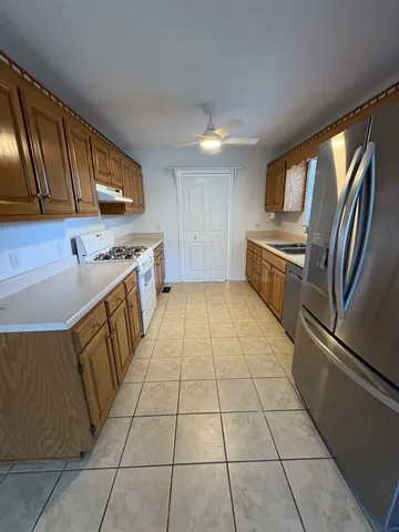 a kitchen with a sink a stove top oven and cabinets