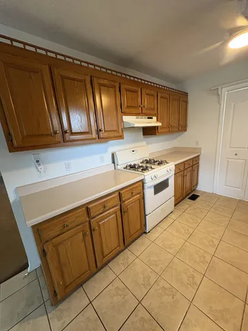 a kitchen with a sink stove and cabinets