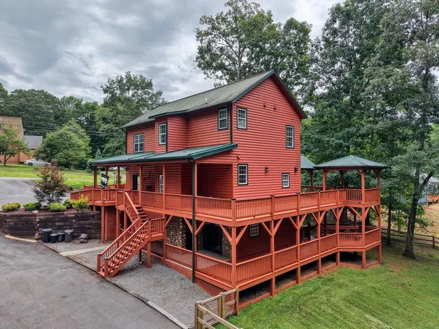 an outdoor view of house with backyard and trees