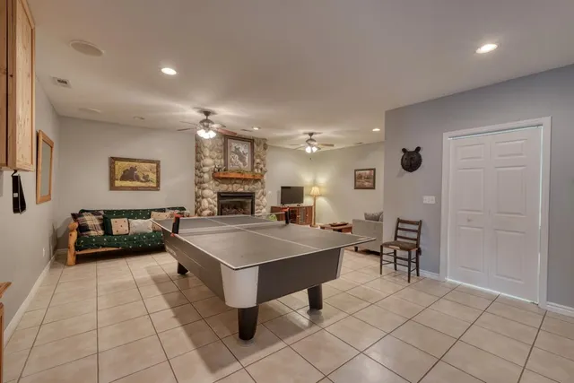 a large room with pool table and a chairs