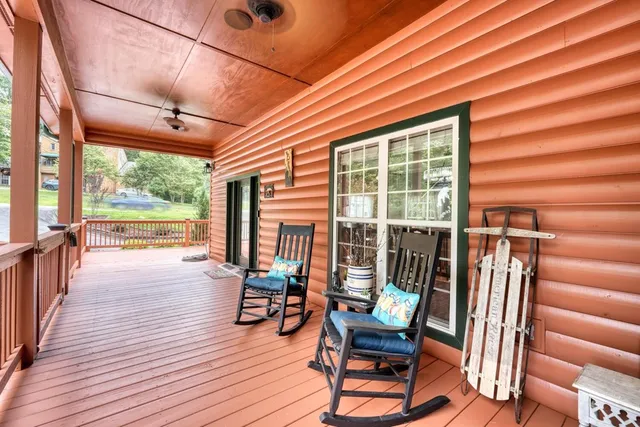 a view of a chairs and table in patio with wooden floor