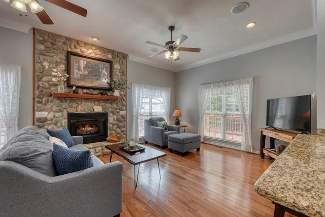 a living room with furniture a flat screen tv and a fireplace