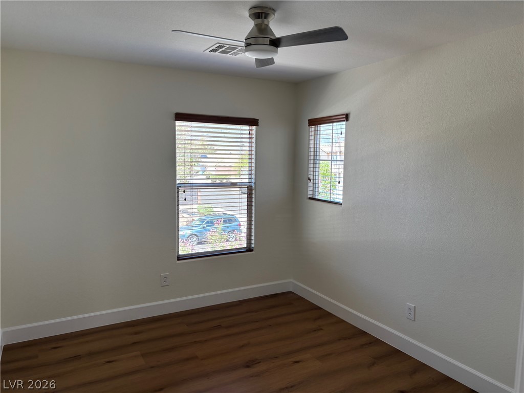 4900 Naff Ridge Drive Las Vegas, NV 89131 - Photo 18 of 21 Warm wood-look flooring and two windows create a welcoming and bright private space.