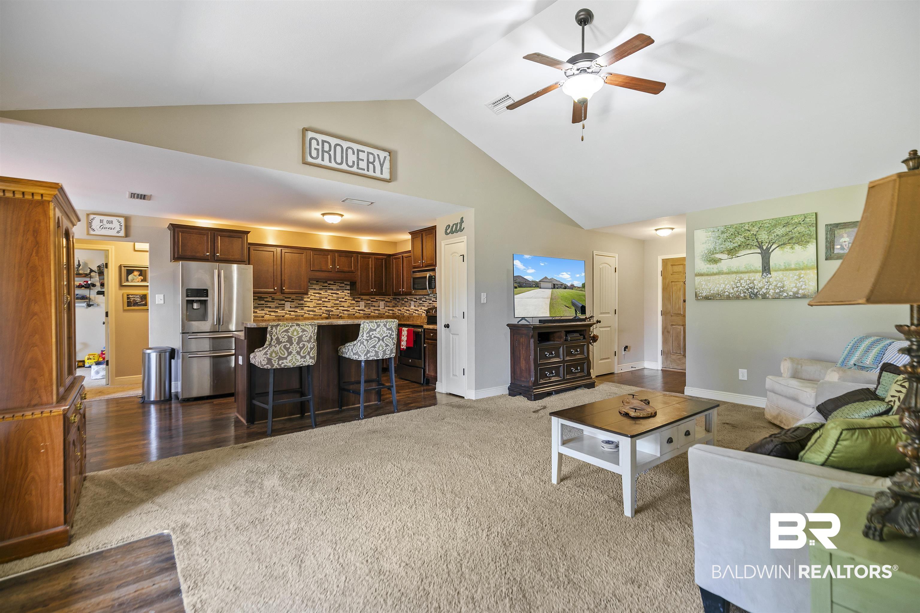18738 Explorer Drive Loxley, AL 36551 - Photo 8 of 38 Living room with carpet floors, high vaulted ceiling, and ceiling fan