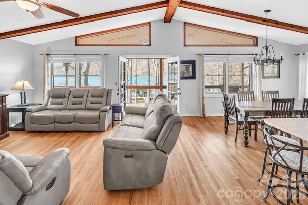 a living room with furniture a wooden floor and a chandelier