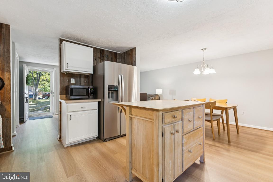2269 Marginella Drive Reston, VA 20191 - Photo 11 of 29 a kitchen with white cabinets and stainless steel appliances