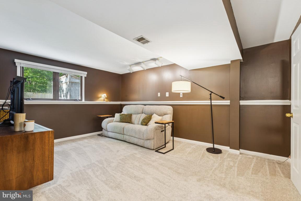 2269 Marginella Drive Reston, VA 20191 - Photo 20 of 29 a living room with furniture and a flat screen tv