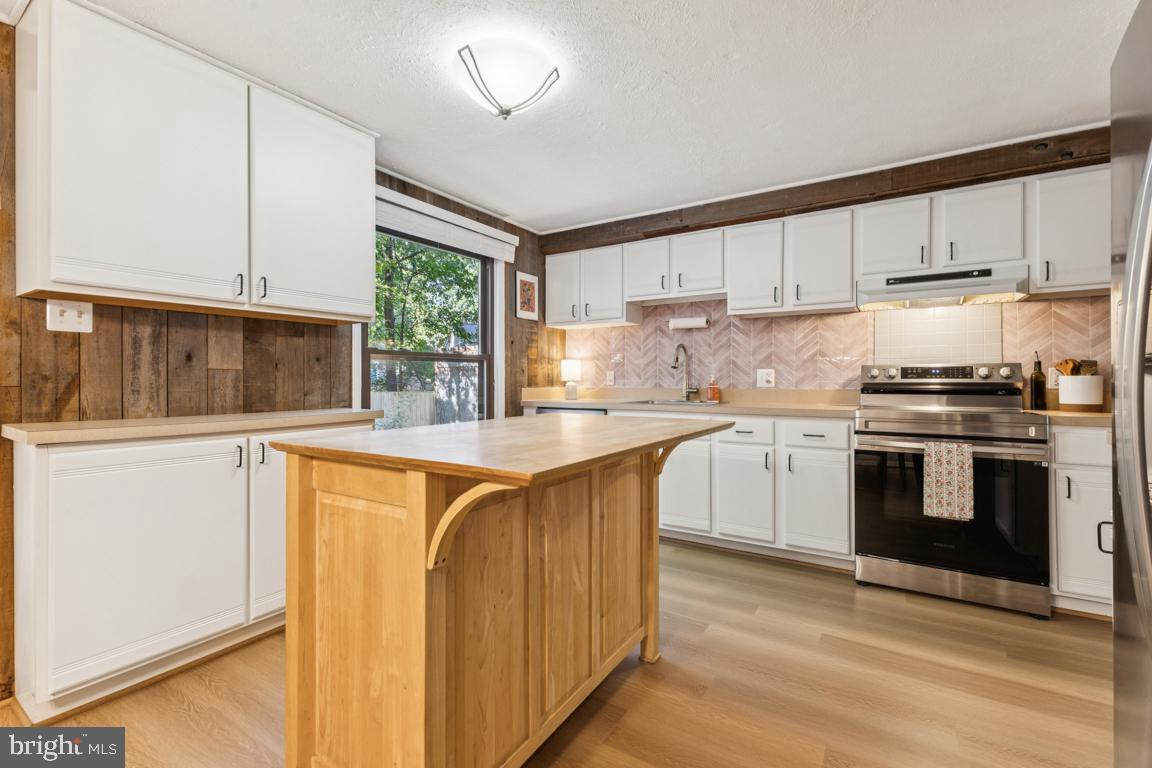 2269 Marginella Drive Reston, VA 20191 - Photo 9 of 29 a kitchen with stainless steel appliances granite countertop a stove a sink and a refrigerator