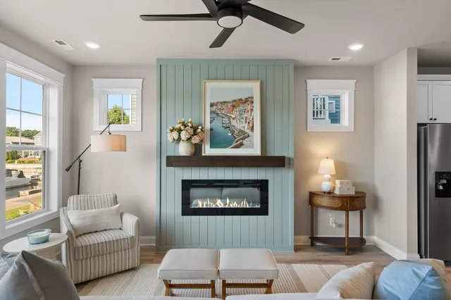 a living room with furniture fireplace and a large window