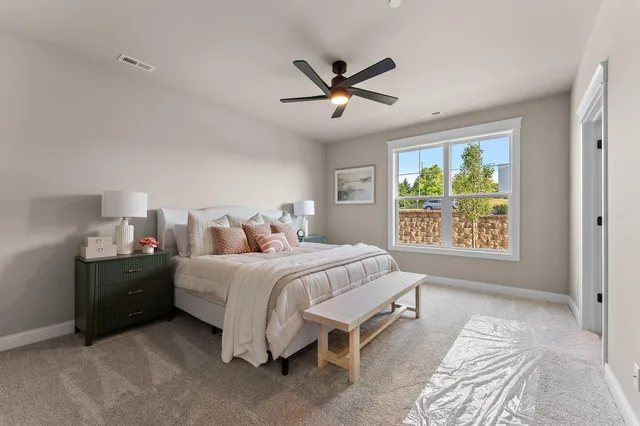 a bedroom with a bed and a lamp