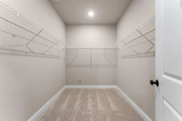 a spacious bathroom with a toilet a sink and mirror