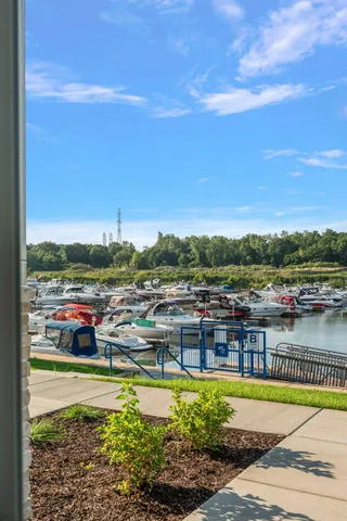 an aerial view of a city with lots of residential buildings ocean and mountain view in back