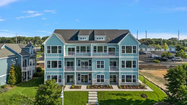a front view of a residential apartment building with a yard