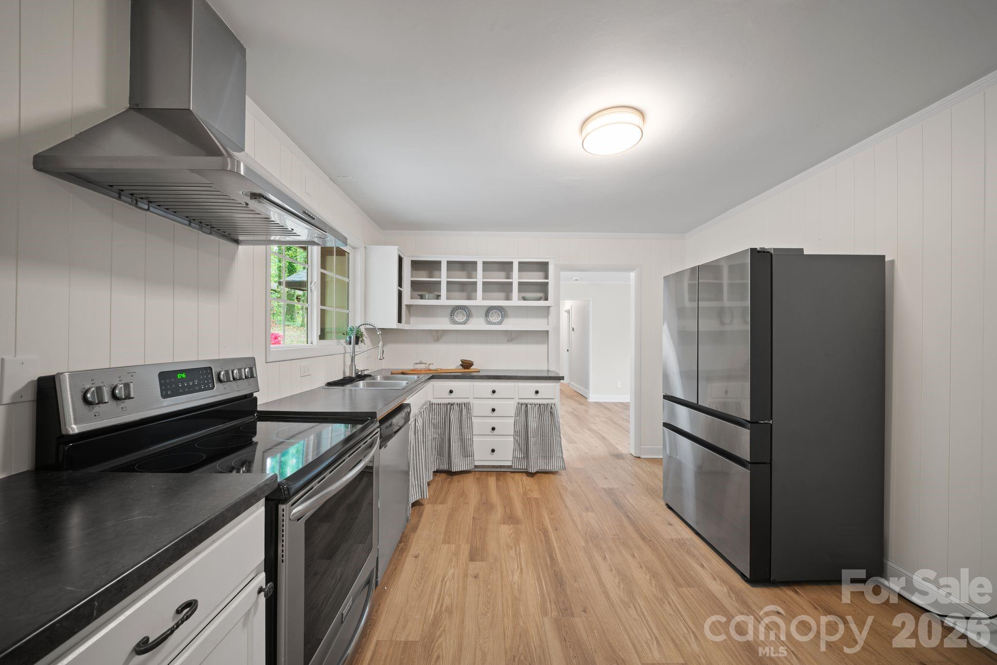 70 Melton Road Candler, NC 28715 - Photo 21 of 35 a kitchen with a refrigerator and a stove