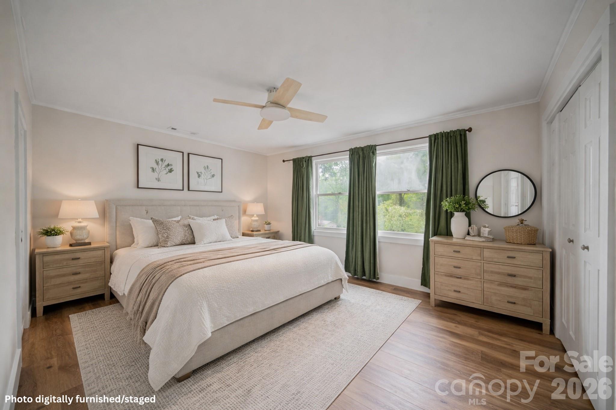 70 Melton Road Candler, NC 28715 - Photo 23 of 35 a bedroom with a bed and a chandelier