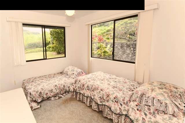 950 Akoa Place Haiku, HI 96708 - Photo 13 of 25 a bedroom with a bed and a window